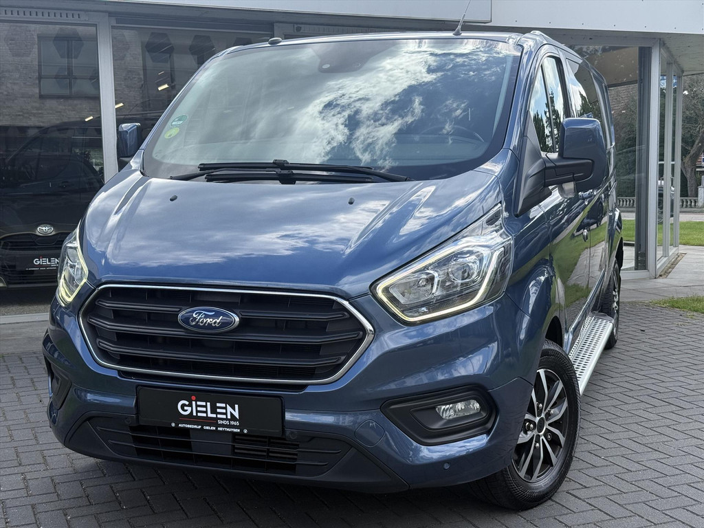 Ford Transit Custom GB 2.0 TDCi 170PK 340 L2H1 Limited | Navigatie, Parkeersensoren, Roofrails, Trekhaak, Dubbele Cabine, Dubbele schuifdeur 54227687-1.jpg | Autobedrijf Gielen